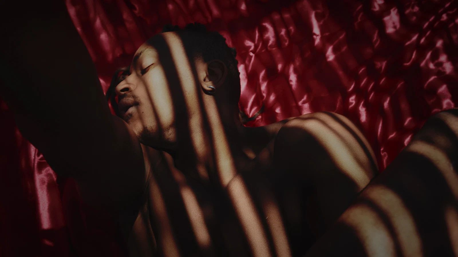 Red satin and patterned shadows in a cinematic close-up